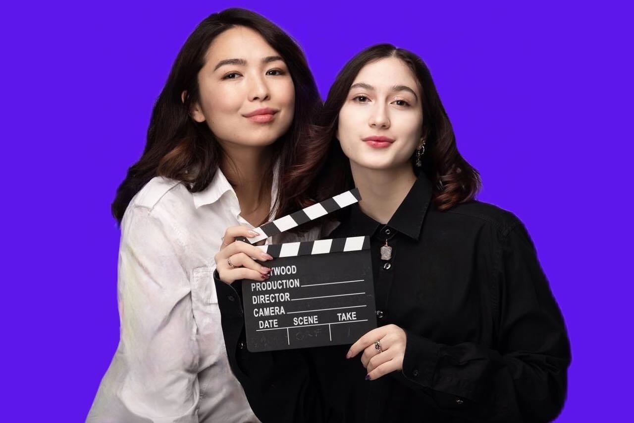 Dana Igembayeva and Ella Vlasenko, founders of LAVANDA, holding a film clapperboard